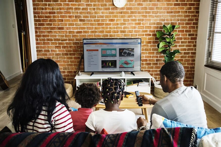 Person using a streaming service while comparing subscription payment options.
